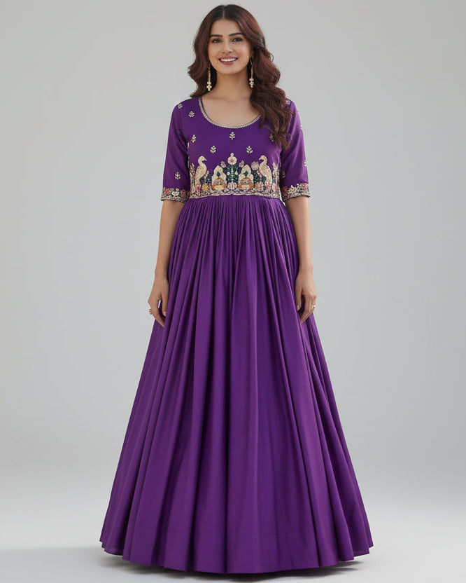 Woman in a purple gown standing in front of a building with floral decorations on the ground.